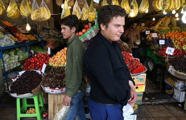 Two Iranian fruit sellers wait for the customer in Tajrish bazaar northern Tehran Iran Tuesday