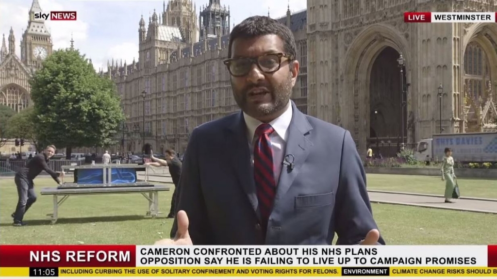 Two magicians prepare to perform a trick behind a Sky News reporter the network says the seemingly live report was never broadcast