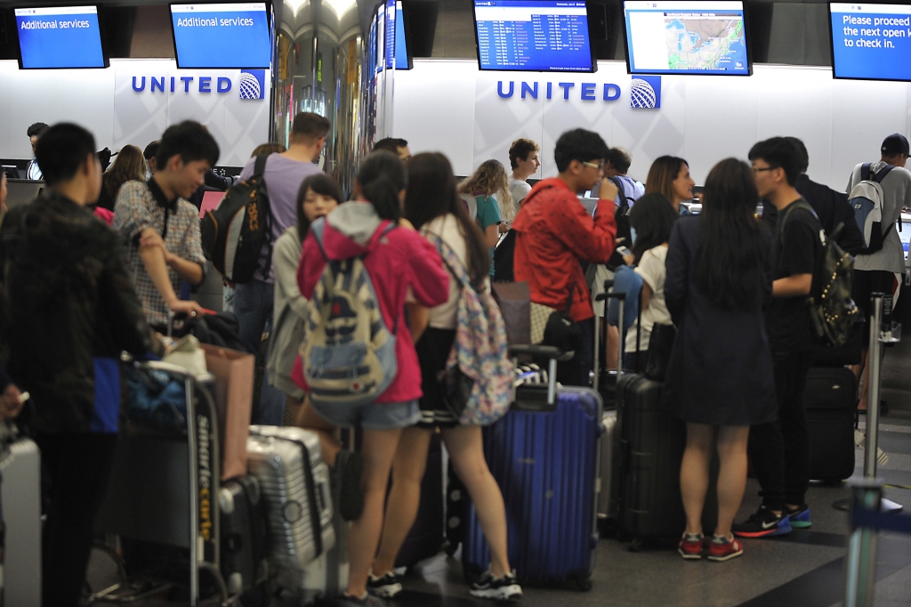 United passengers are stuck in long lines after the airline’s computer system