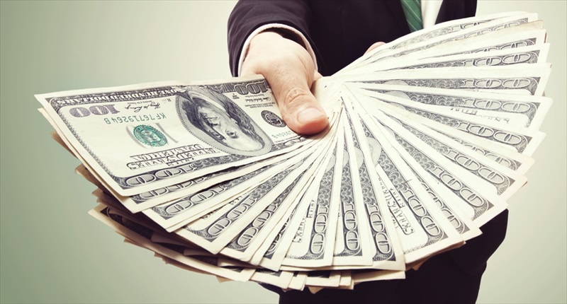 Businessman-displaying-a-spread-of-cash-Shutterstock-800x430