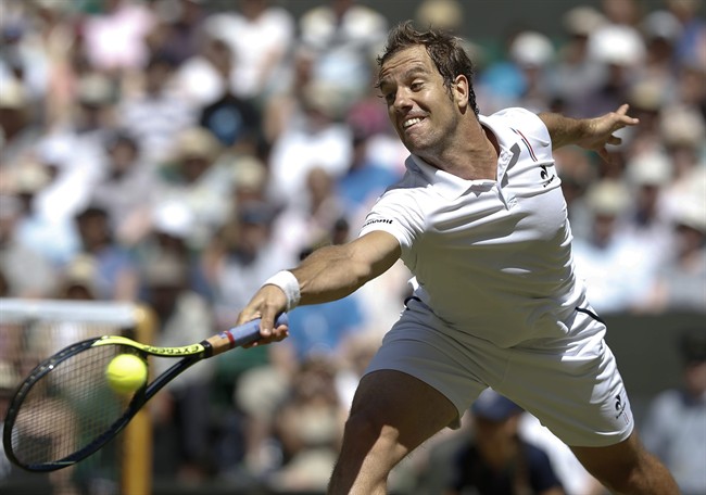 Richard Gasquet of France returns a shot to Novak Djokovic of Serbia during the men