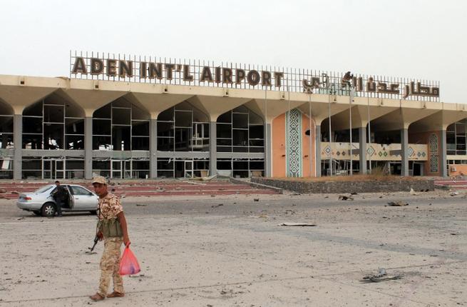 Armed militiamen loyal to Yemen's fugitive President Abderabbo Mansour Hadi stand at the entrance to Aden's international airport