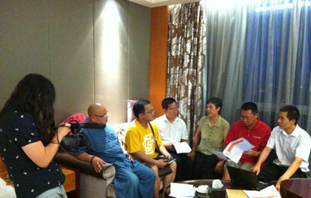 Zhou Shifeng fourth left and Wu Gan second left talk to petitioners