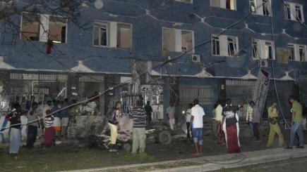 Somali security forces and civilians gather outside the Weheliye hotel after it was attacked by militants