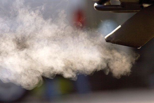 Polluted air billows out of a car’s exhaust pipe