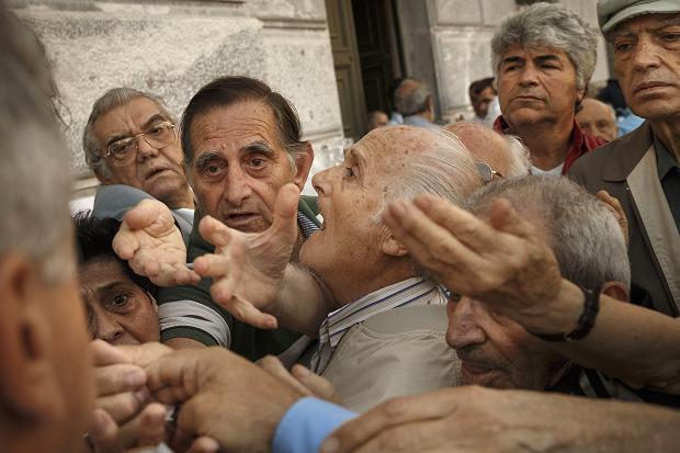 About 1,000 bank branches around the country were ordered by the government to reopen Wednesday to help desperate pensioners without ATM cards cash up to 120 euros