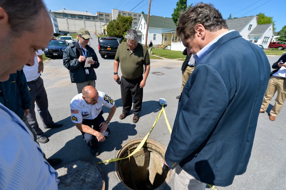 New York Gov. Andrew Cuomo’s office shows Cuomo right with Steven Racette center superintendent of Clinton Correctional Facility looking at a manhole in Dannemora N.Y. on June 6 before Racette was placed on administrative leave. A pair of inmate