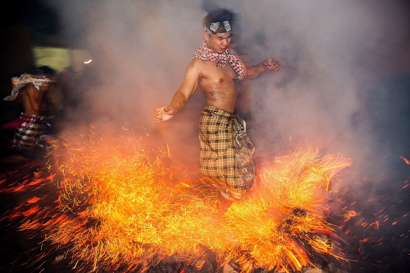 A Balinese man kicks up fire during the Mesabatan Api ritual in Gianyar Bali Indonesia. Agung Parameswara  Getty Image