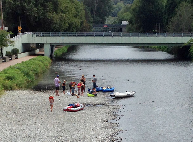 A group of rafters take a break just past the library in downtown Renton