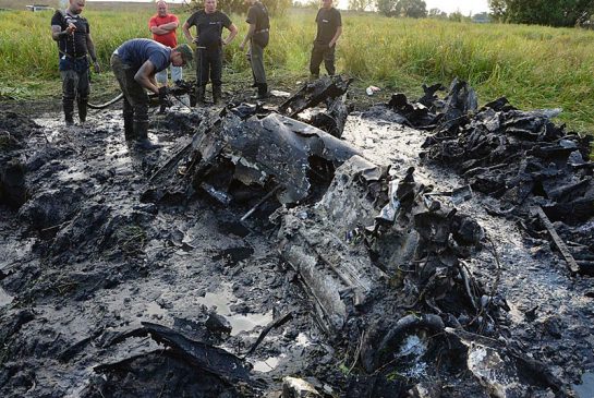 Firefighters retrieve the remains of a Soviet WW II fighter-bomber plane and its crew a from muddy riverbed near Wyszogrod Poland