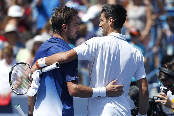 Novak Djokovic of Serbia right hugs Stanislas Wawrinka of Switzerland after their quarterfinal match at the Western & Southern Open tennis tournament Friday Aug. 21 2015 in Mason Ohio. Djokovic defeated Wawrinka 6-4 6-1. (AP