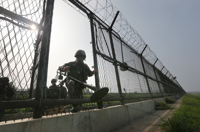 An army soldier engages in a mission to detect minds near the inter Korean border on Wednesday