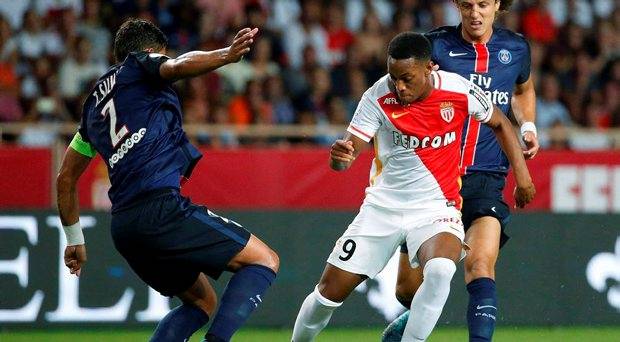 Monaco's Anthony Martial challenges Paris St Germain's Thiago Da Silva and David Luiz during their Ligue 1 soccer match at Louis II stadium in Monaco