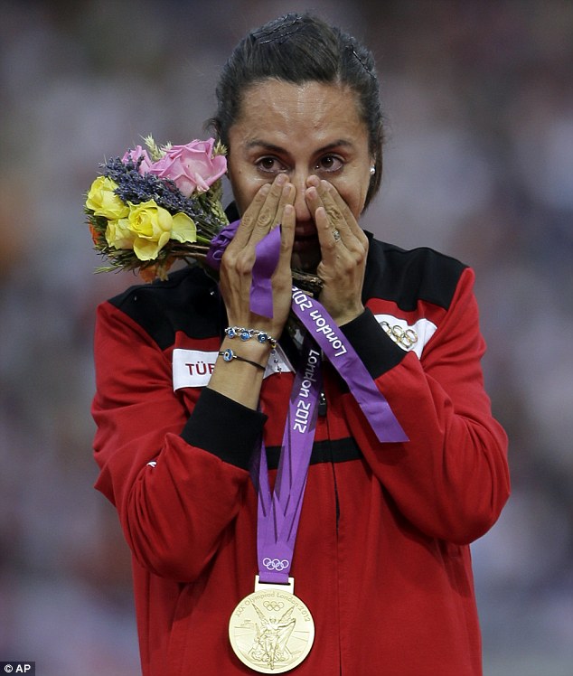 Asli Cakir Alptekin poses with the gold medal which she won in the London 2012 Olympic Games