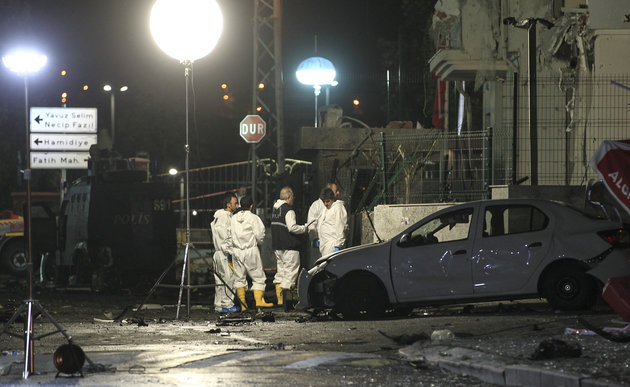 Turkish forensic police officers work at the site of an explosion at a police station in Istanbul's Sultanbeyli neighbourhood early Monday Aug. 10 2015