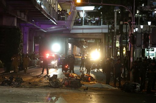 Debris and overturned motorcycles are strewn across the intersection across from the Erawan Shrine after an explosion in Bangkok Monday Aug. 17 2015. A large explosion rocked a central Bangkok intersection during the evening rush hour killing a number