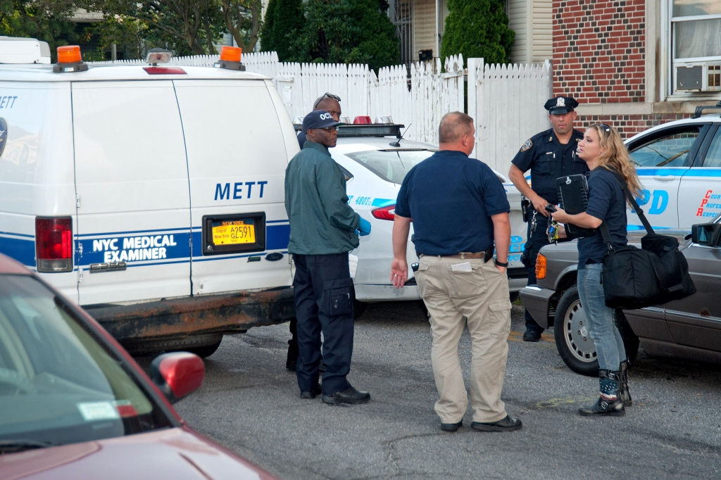 Authorities gather at the scene outside the apartment