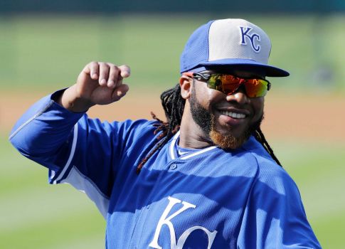 Kansas City Royals’ Johnny Cueto stretches and smiles before the Royals play the Cleveland Indians in a baseball game Tuesday