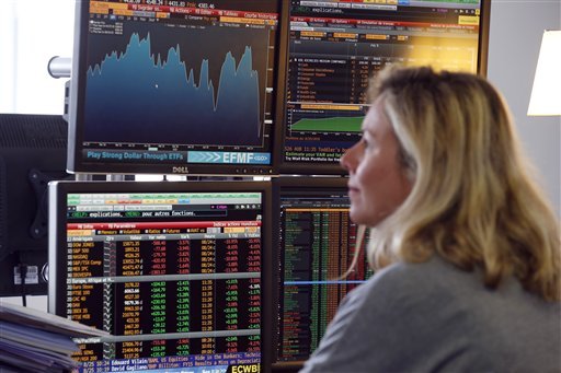 A fund manager looks at screens displaying activities of shares on the French Stock Exchange in a financial analysis office in Paris France Tuesday Aug. 25 2015. Chinese stocks fell Tuesday for a fourth day hitting an eight-month low amid signs Beij