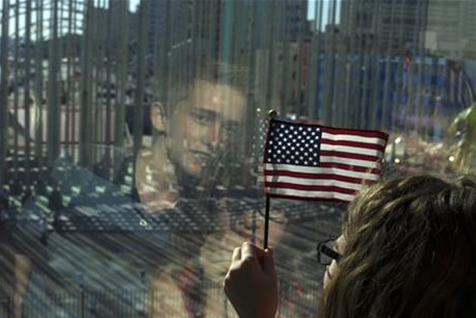 Family members of U.S. Embassy employees look out at the staging area before the start of a flag raising ceremony at the newly opened U.S. Embassy in Havana Cuba Friday Aug. 14 2015. Washington's top diplomat came to Havana on Friday to raise the St