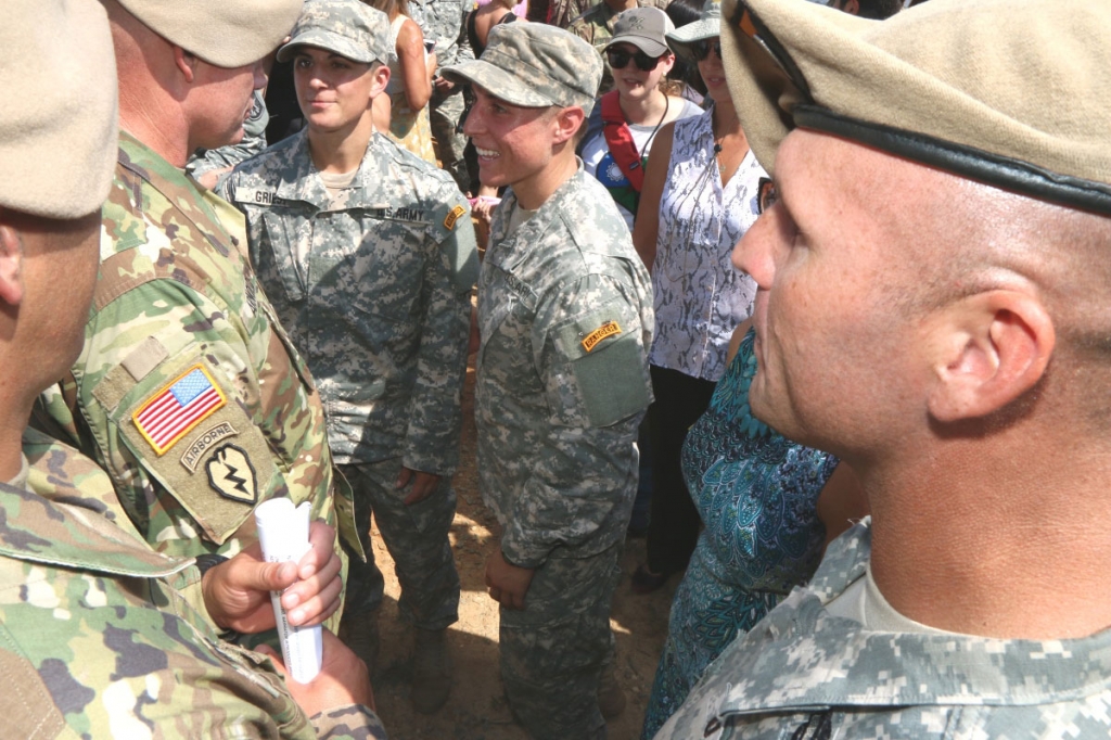 Capt Kristen Griest left and 1st Lt Shaye Haver talk to Command Sgt Major Curtis Arnold Jr after receiving their Ranger Tabs at