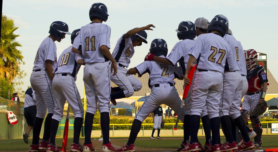 The Sweewater Valley team meets Ari Armas at home plate on his three-run home run against Utah in the Little League Western Regional in San Bernardino. Sweetwater vs. Utah 11-1