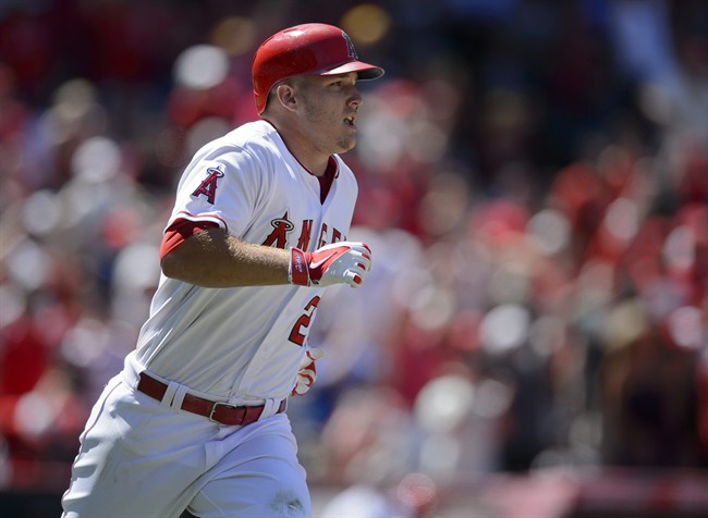 Los Angeles Angels Mike Trout runs toward first base after hitting a grand slam home run off of Texas Rangers pitcher Spencer Patton not