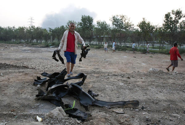 Firefighter rescued from blast zone in China's Tianjin port