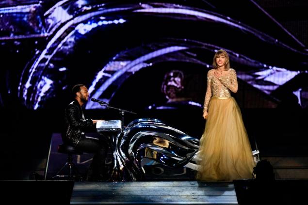 John Legend joined Taylor Swift onstage at her L.A. concert Tuesday to play his hit “All of Me.”