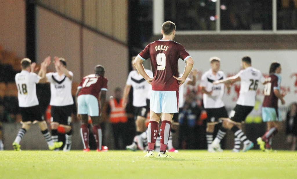 DEJECTED Burnley’s Sam Vokes looks on as Port Vale’s players celebrate their late winner in Tuesday’s cup tie