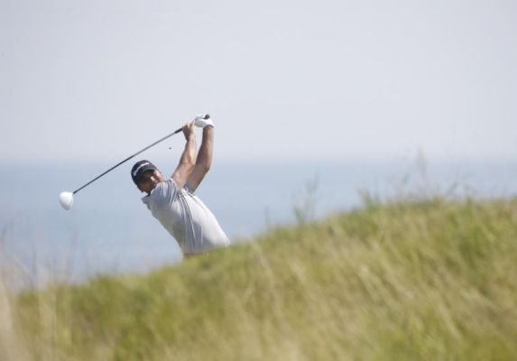 Jason Day of Australia hits on the fifth