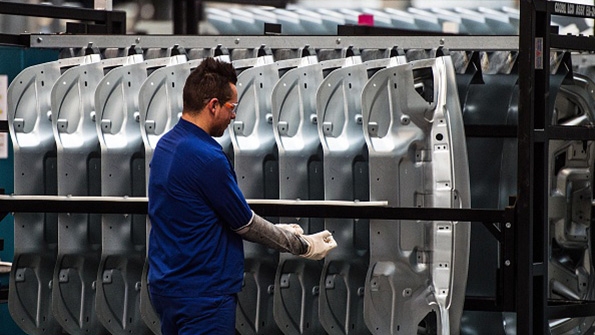 A Ford factory worker on the assembly line