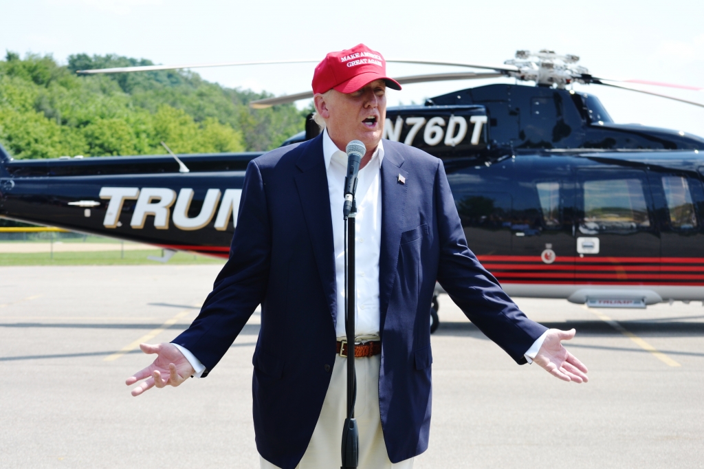 Donald Trump answers questions from reporters after arriving in his helicopter