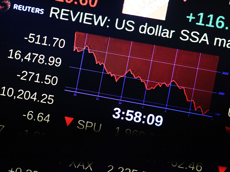 A screen on the floor of the New York Stock Exchange shows the market numbers near the close of the day