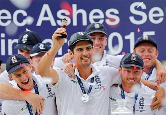 England captain Alastair Cook holds up the Ashes urn as he and his teammates celebrate their series win over Australia