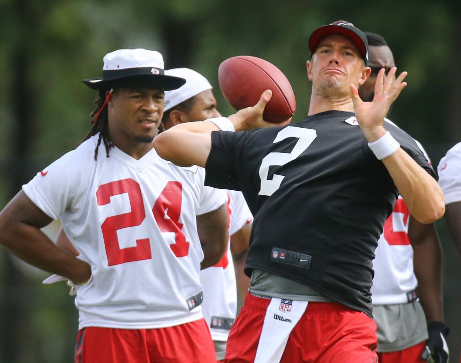 Atlanta Falcons running back Devonta Freeman watches as quarterback Matt Ryan launches a deep pass during NFL football training camp Wednesday Aug. 19 2015 in Flowery Branch Ga