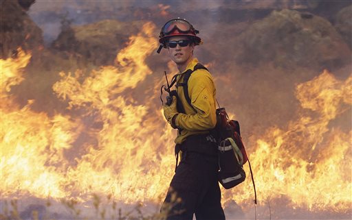 Crews battling the windstoked blaze took advantage of cooler temperatures to clear brush and expand containment