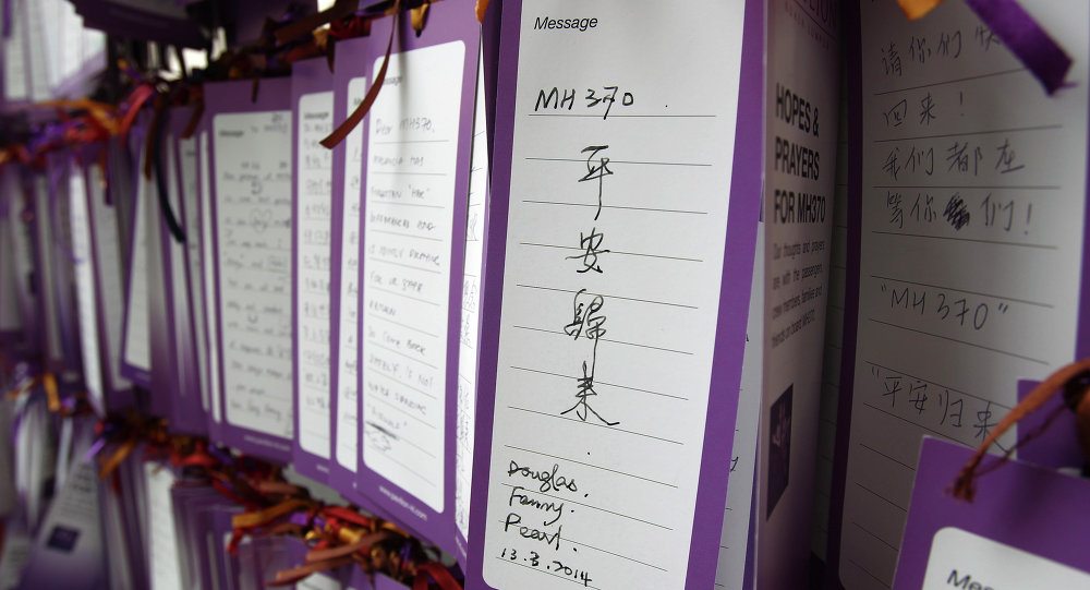 A message card reading MH370 comes back safely is tied up for passengers aboard a missing Malaysia Airlines plane