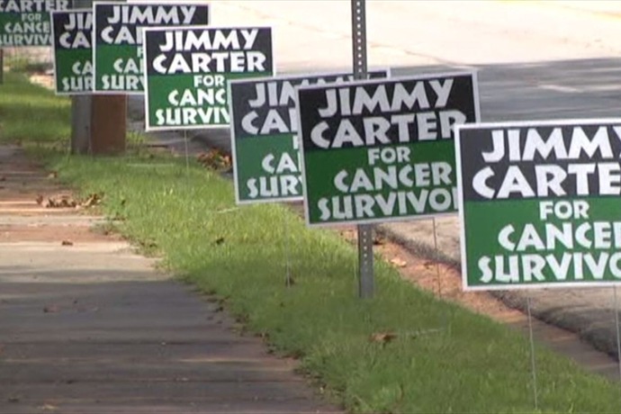 Friends and neighbors show their support for former President Jimmy Carter during his fight against cancer with campaign-style signs