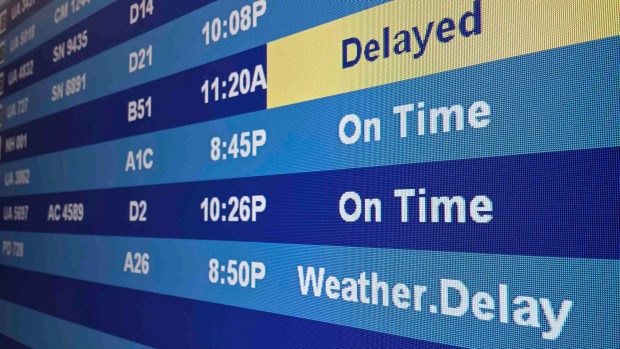 Flight information including delays are on display on a screen at the Washington Dulles Airport