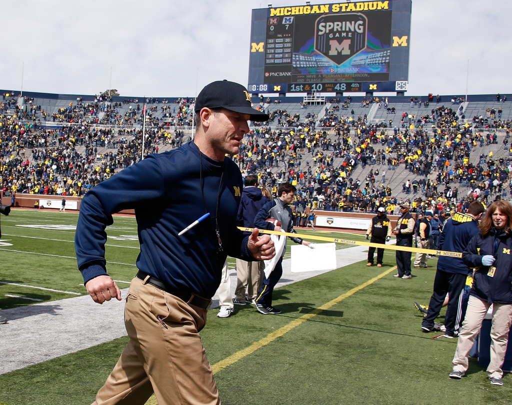 ANN ARBOR MI- APRIL 04 Head coach Jim Harbaugh of the Michigan Wolverines leaves the field after the Michigan Football Spring Game