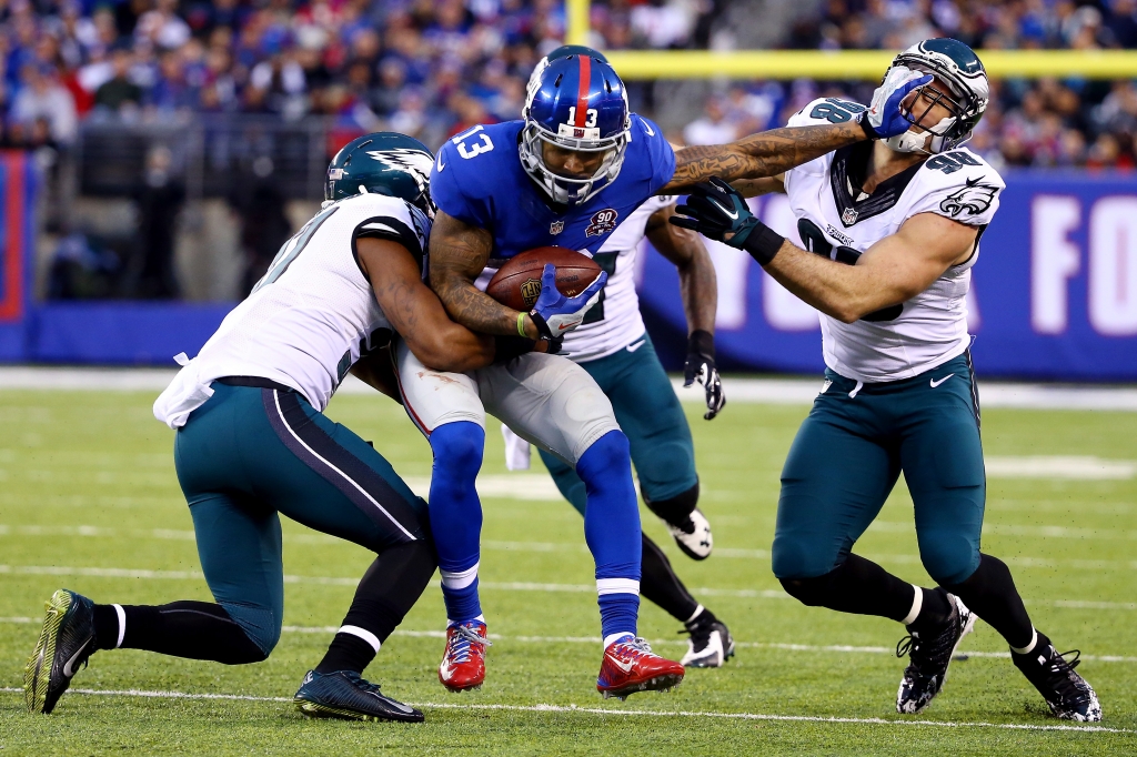 EAST RUTHERFORD NJ- DECEMBER 28 Odell Beckham #13 of the New York Giants runs with the ball as Connor Barwin #98 of the Philadelphia Eagles tries to make the tackle during a game at Met Life Stadium