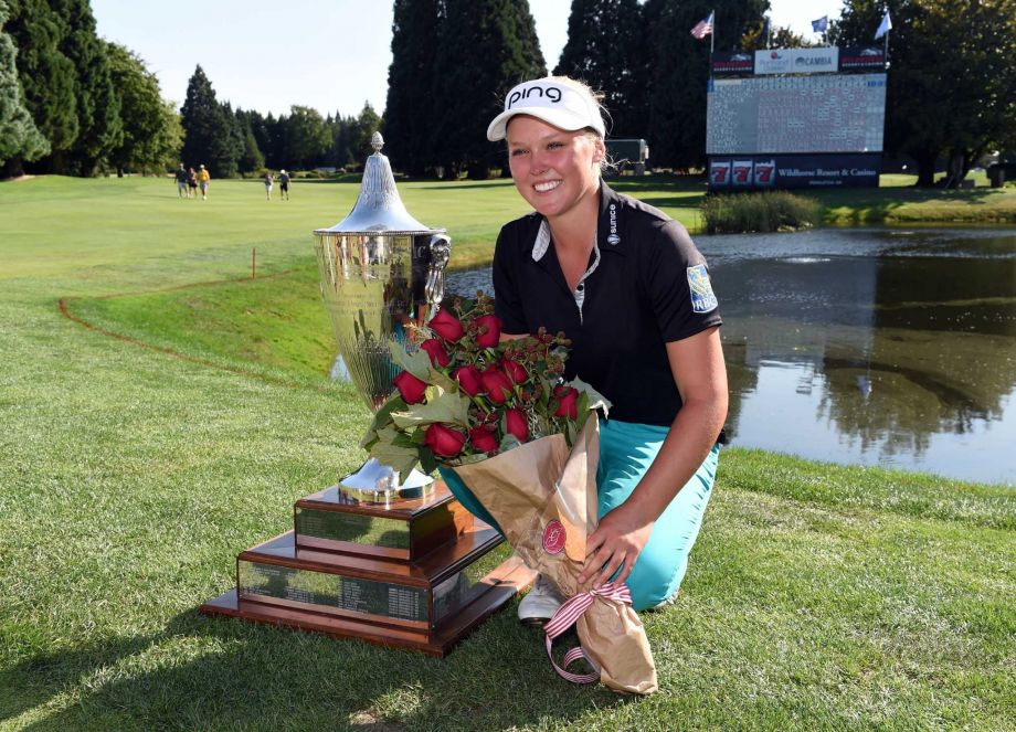 Brooke M. Henderson of Canada poses with the trophy on the 18th hole after winning the Cambia Portland Classic golf tournament in Portland Ore. Sunday Aug. 16 2015