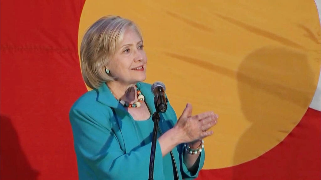 Hillary Clinton in front of the Colorado state flag in Denver on Tuesday