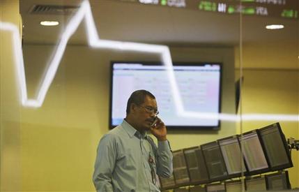 An Indonesian talks his mobile phone inside a monitoring room at the Indonesia Stock Exchange in Jakarta Indonesia Tuesday Aug. 25 2015. Chinese stocks tumbled again Tuesday after their biggest decline in eight years while most other Asian markets reb