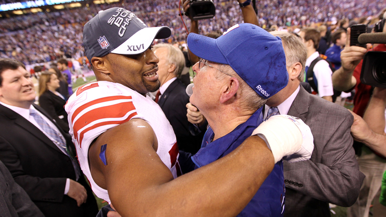 Osi Umenyiora hugs Giants coach Tom Coughlin after defeating the Patriots in Super Bowl XLVI at Lucas Oil Stadium