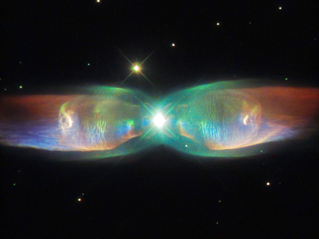 This Hubble image shows a bipolar planetary nebula named the Twin Jet Nebula located about 5,560 light-years away in the constellation Ophiuchus. Bipolar planetary nebulae are formed when the central object is not a single star but a binary system. Stud