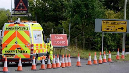 Police vehicles on the eastbound entry sliproad of junction four of the M54 near Telford in Shropshire following the discovery of a human skull and other skeletal remains