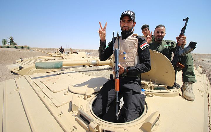 Members of the allied Iraqi forces consisting of the Iraqi army and fighters from the Popular Mobilisation units pose for