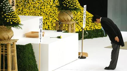 Shinzo Abe offers prayers for the war dead during a memorial service at Nippon Budokan martial arts hall in Tokyo